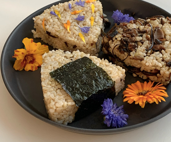 Onigiri rice balls with edible flowers and mushrooms